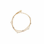 Brățară de picior aurie, design minimalist și elegant din lant dublu cu 4 pietricele si 3 inimioare albe.