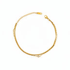 Brățară de picior aurie, design minimalist și elegant din 2 randuri de lant unul sarpe si unul sibtire cu o pietricica in mijloc.