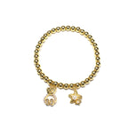 Brățară pe elastic cu bile aurii și charm cu ursulet si stea de mare