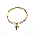 Brățară pe elastic cu bile albe și aurii și charm cruciulita cu pietre negre